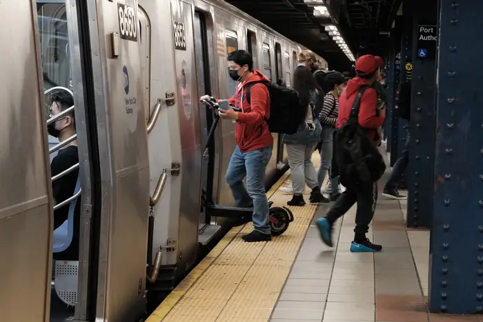 People walk through a Manhattan subway station on May 24, 2022.